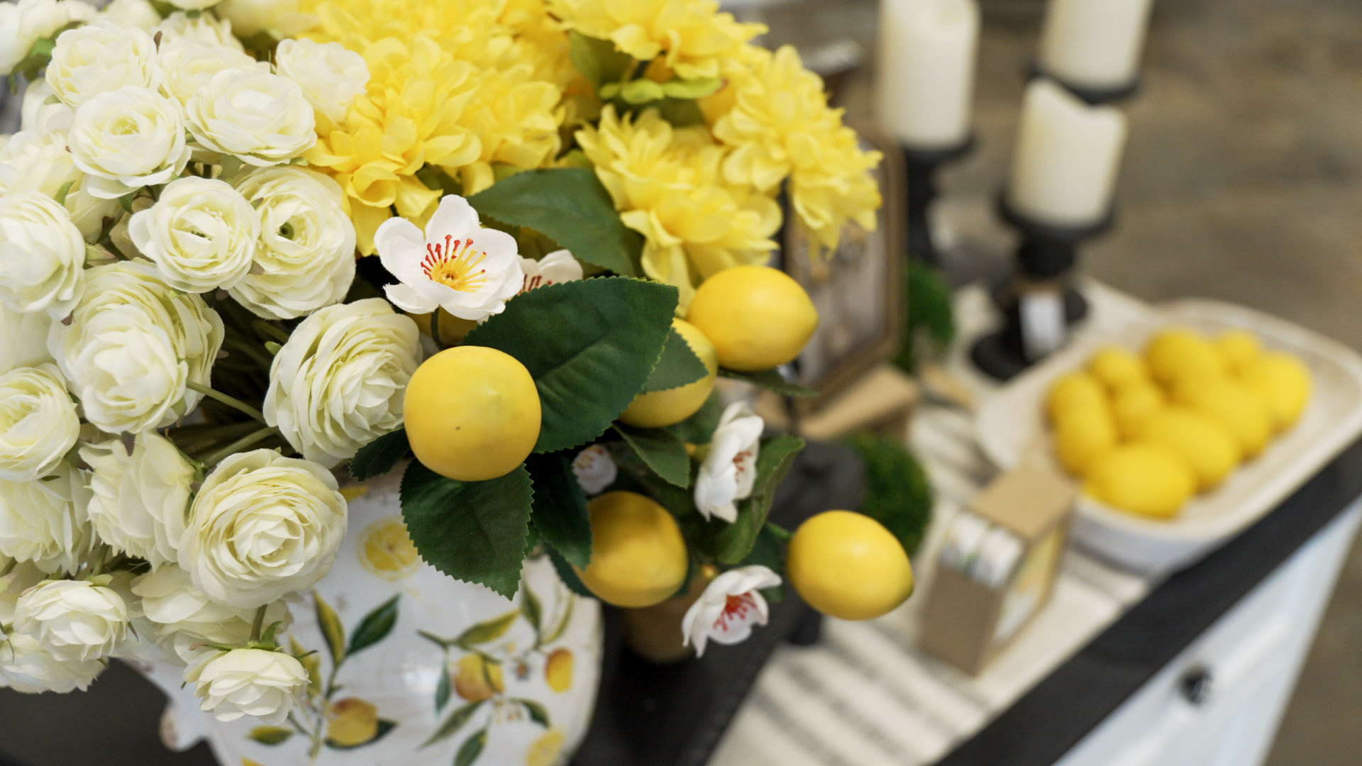 Lemons and white flowers styled in a vase at a boutique vendor display
